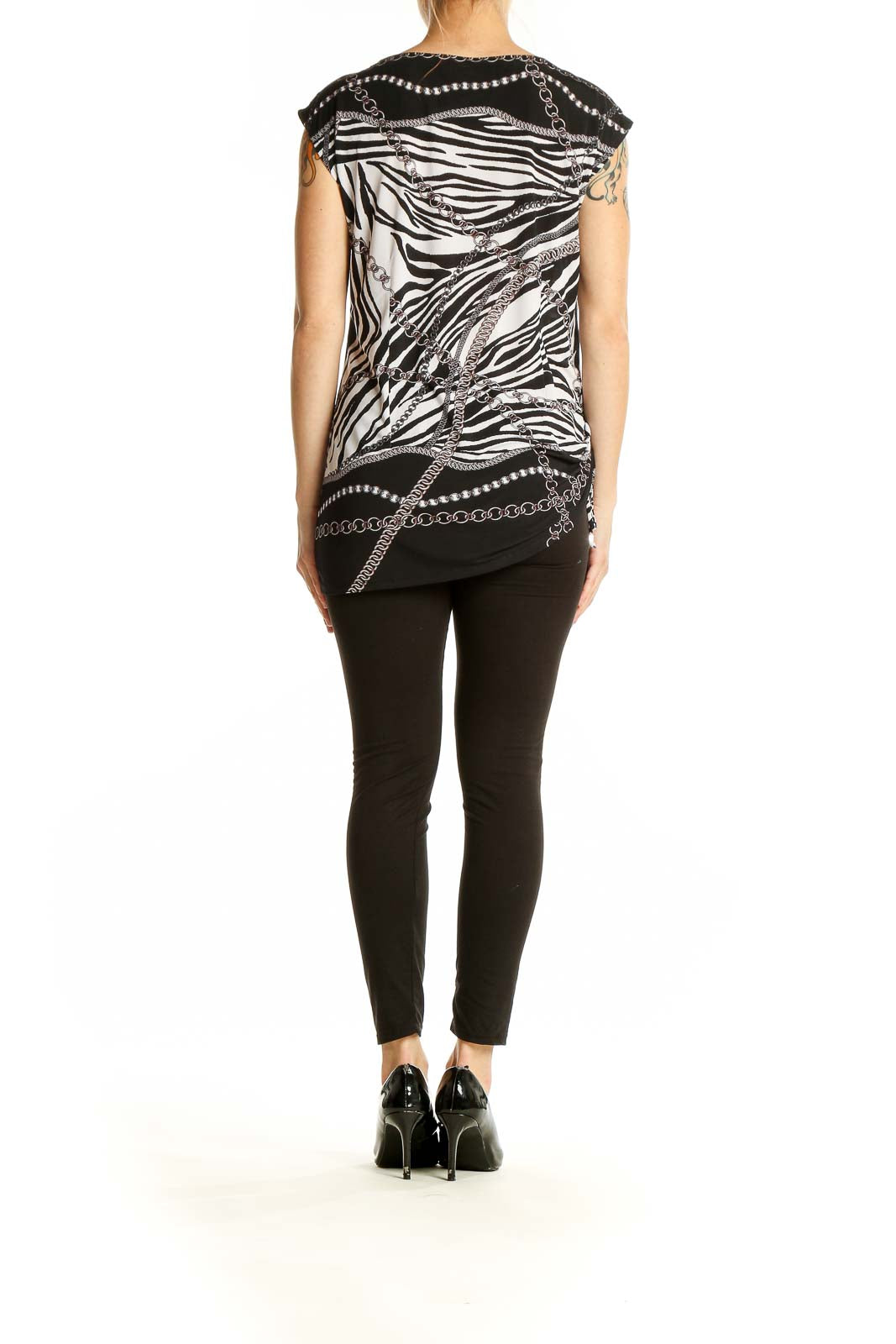 Side view of Cache black and white zebra print sleeveless top on model