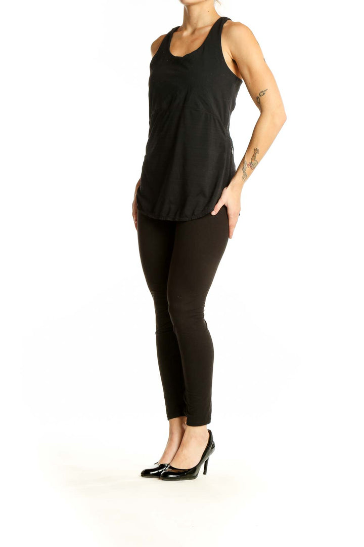 Front view of black Athleta performance tank top with racerback design