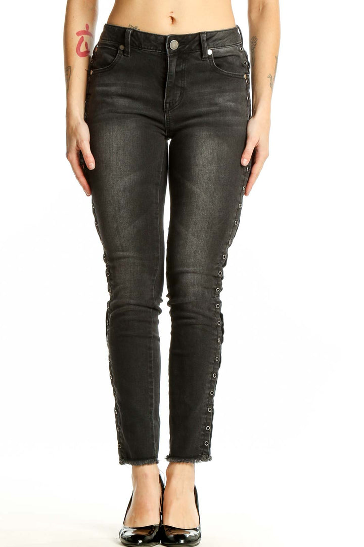 Front view of black distressed skinny jeans with lace-up sides