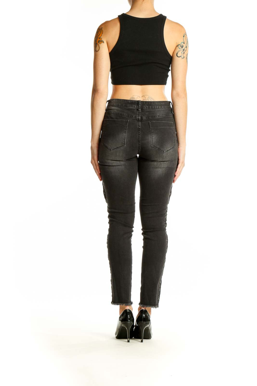 Back view of black distressed skinny jeans with lace-up sides