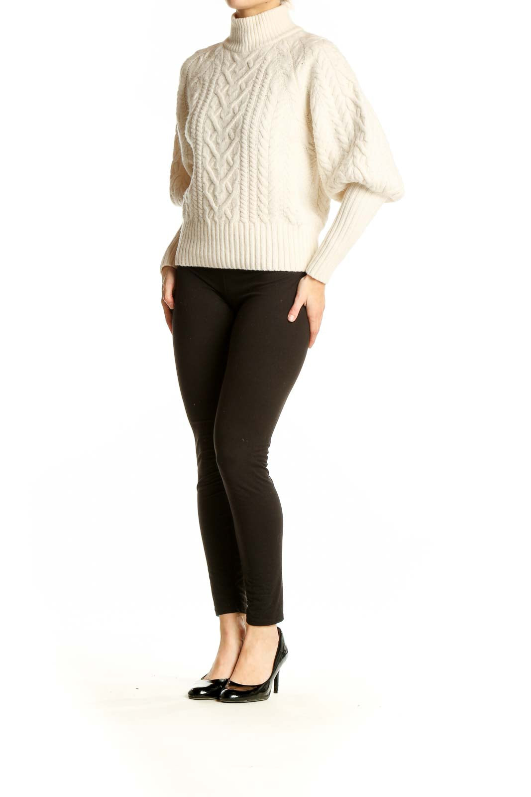 Front view of BCBG MaxAzria cream cable knit turtleneck sweater with balloon sleeves