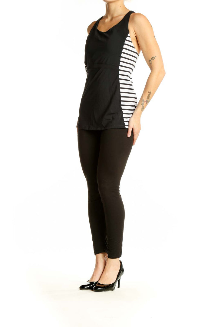 Front view of black Athleta tank top with white side stripes