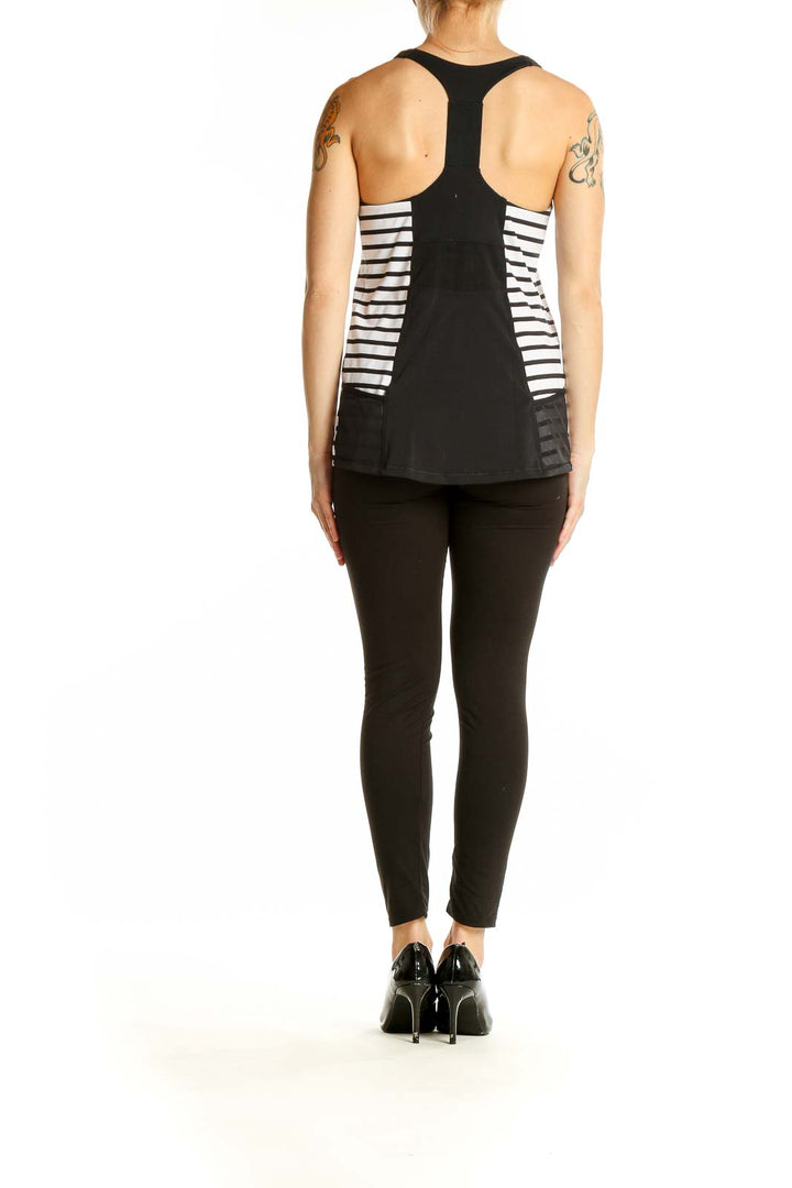 Side view of black Athleta tank top showing white striped panel