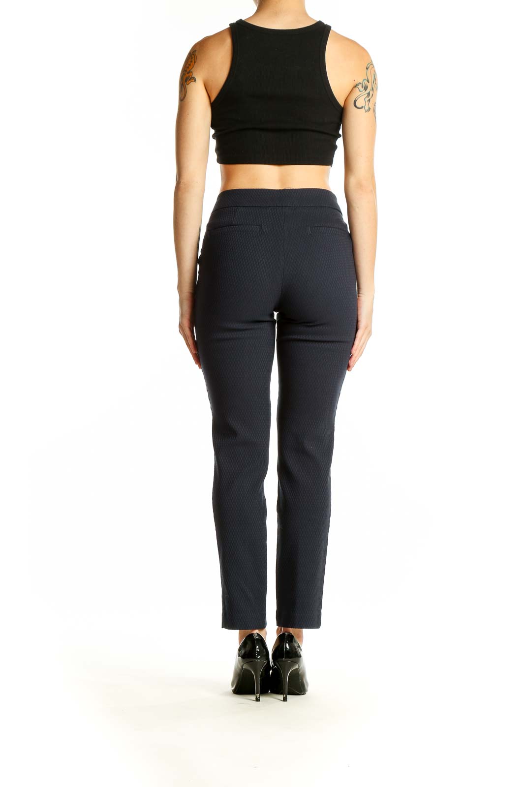 Back view of Dalia black textured slim fit trousers with crop top on model