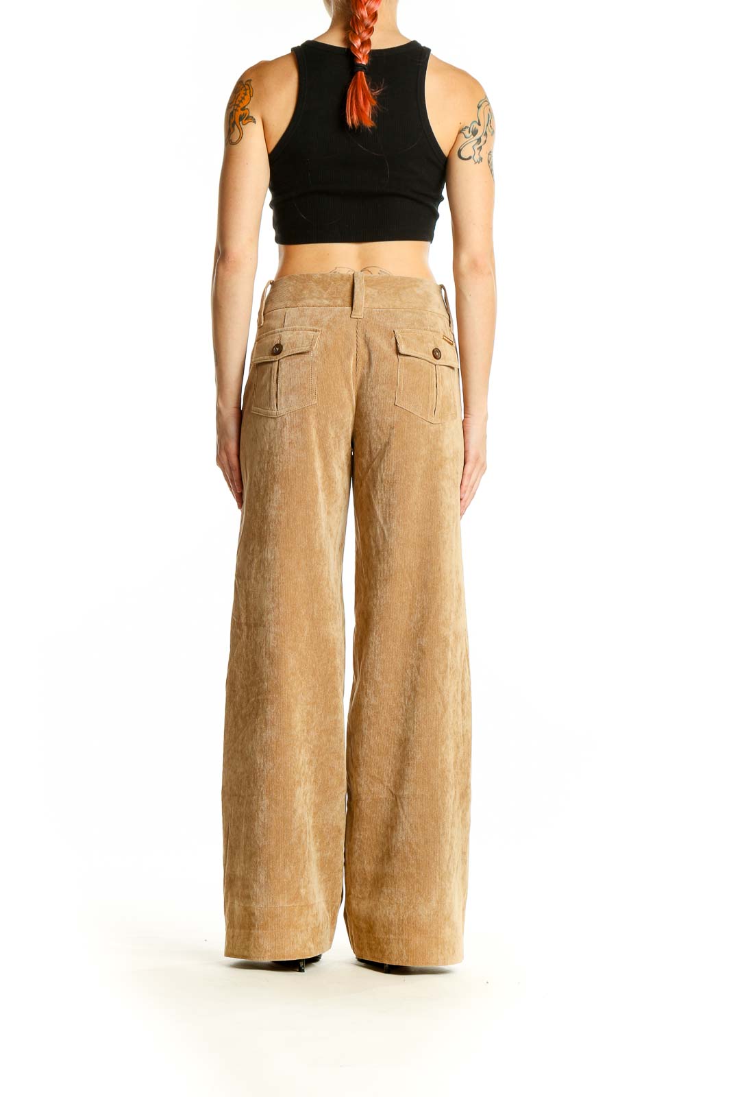 Side view of model wearing Michael Kors tan corduroy wide-leg trousers with black top