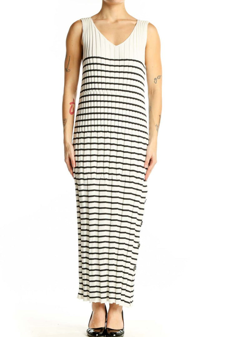 Front view of Qualite white and black striped maxi dress with V-neck