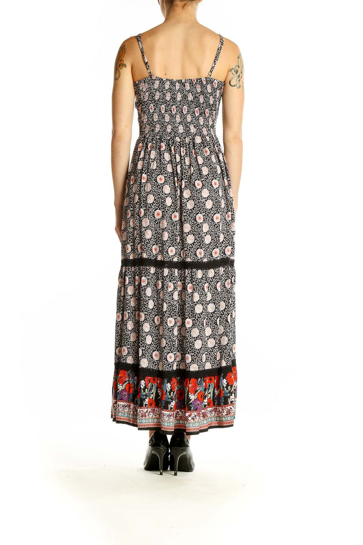 Side view of SilkRoll black floral maxi dress showing pattern details