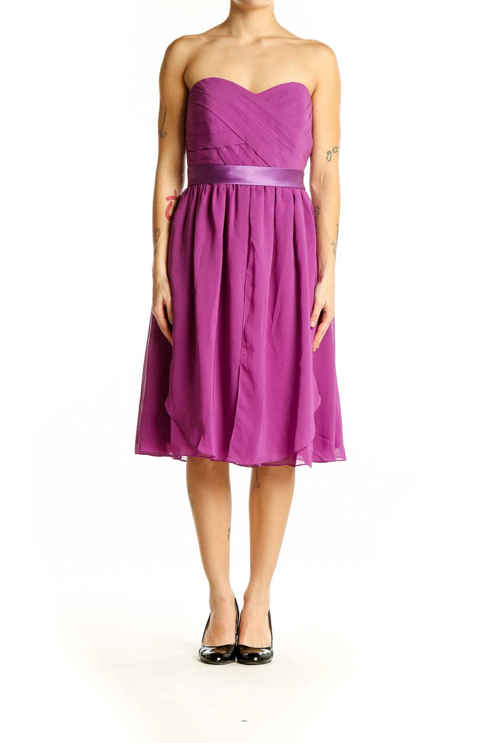 Front view of purple strapless cocktail dress with ruched bodice