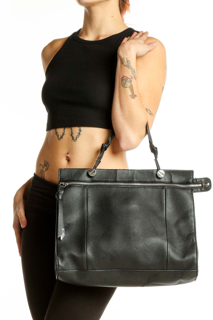 Front view of Foley + Corinna black leather tote bag with zipper detail