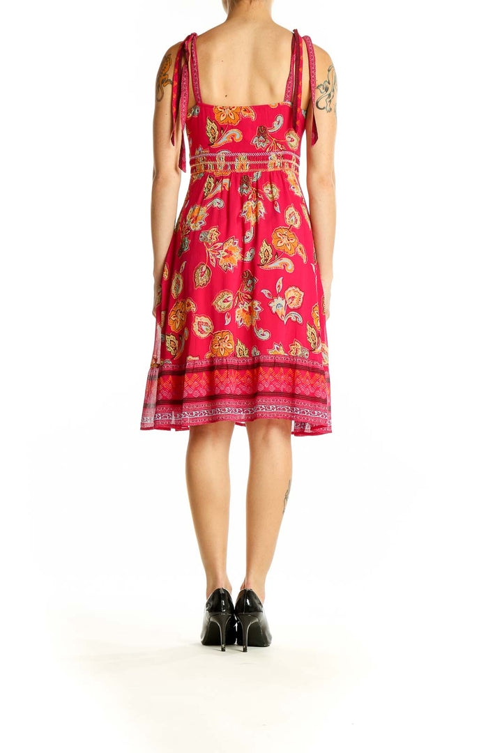 Side view of Esprit pink floral sundress showing empire waist and border print hem