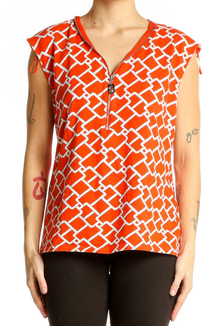 Front view of Michael Kors orange geometric print sleeveless top with V-neck and zipper detail