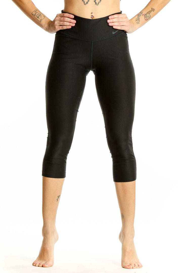 Front view of black Nike capri leggings on woman