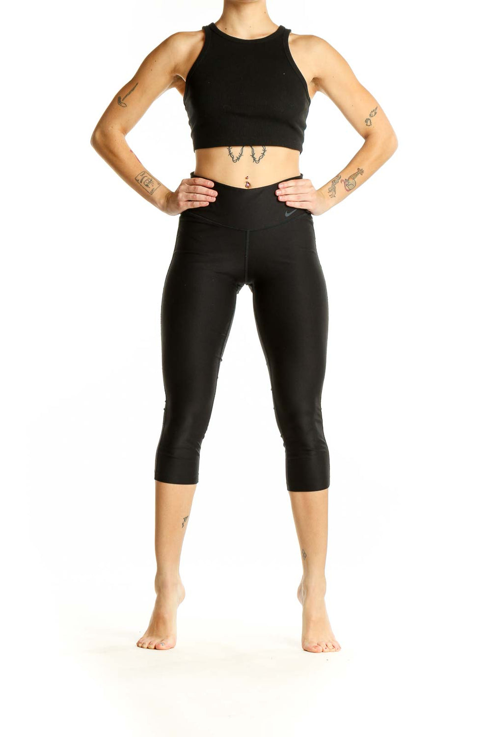 Front view of black Nike capri leggings on woman