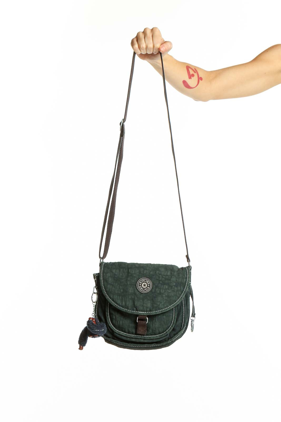 Front view of Kipling green suede crossbody bag with flap closure