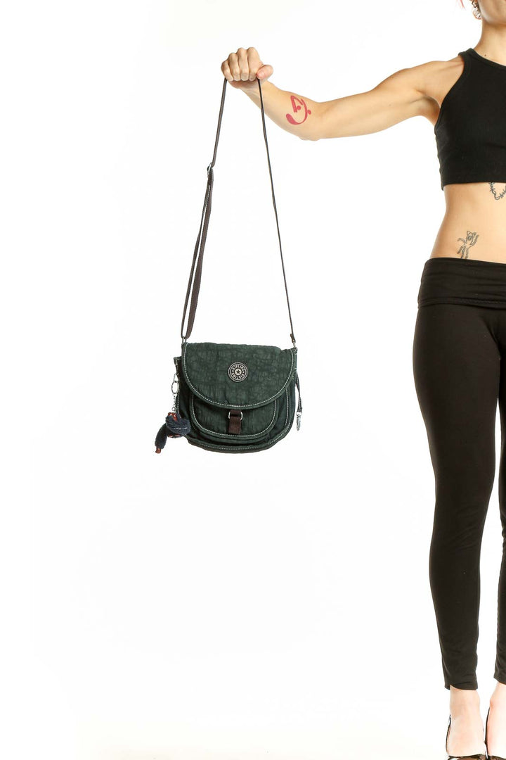 Front view of Kipling green suede crossbody bag with flap closure