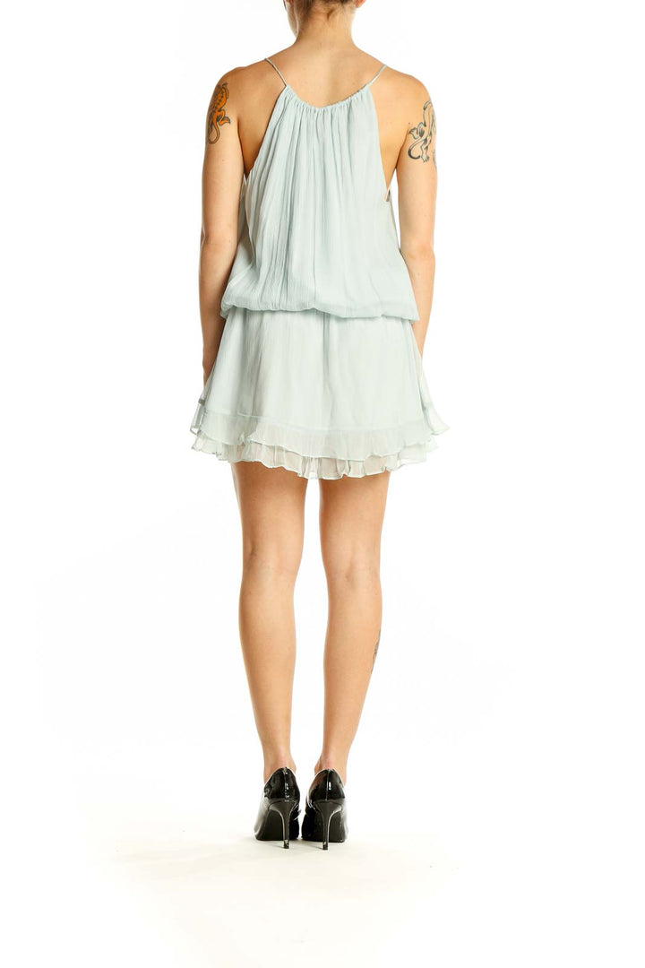 Side view of mint green flowy ruffle mini dress by Elizabeth and James