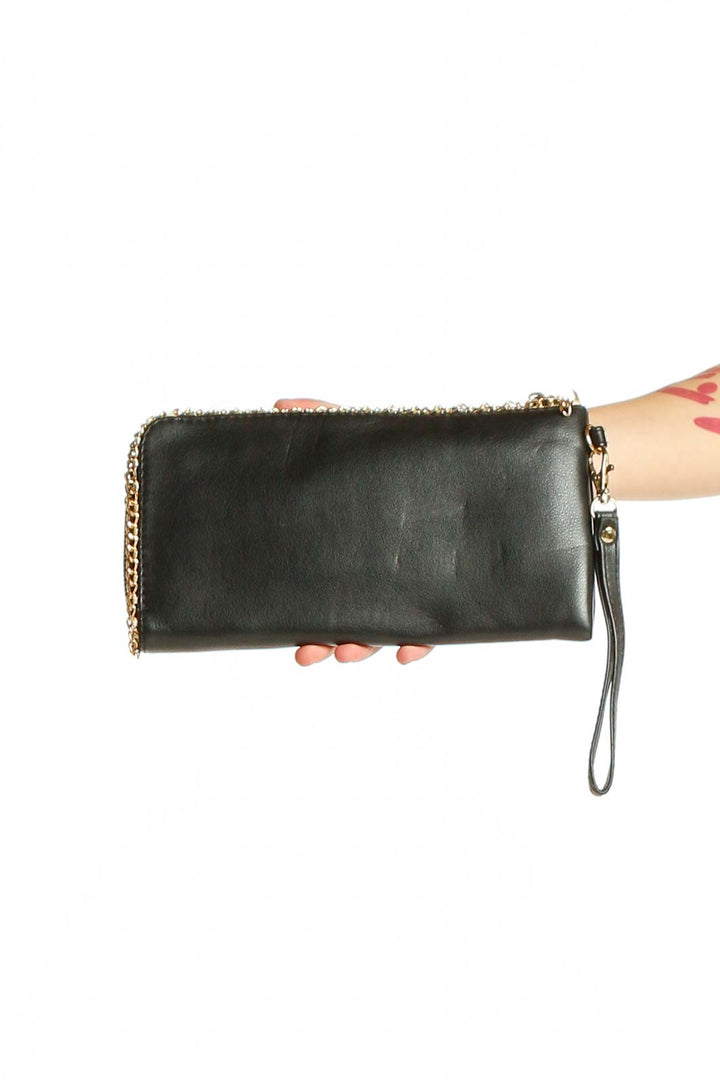 Front view of black leather clutch with gold chain strap