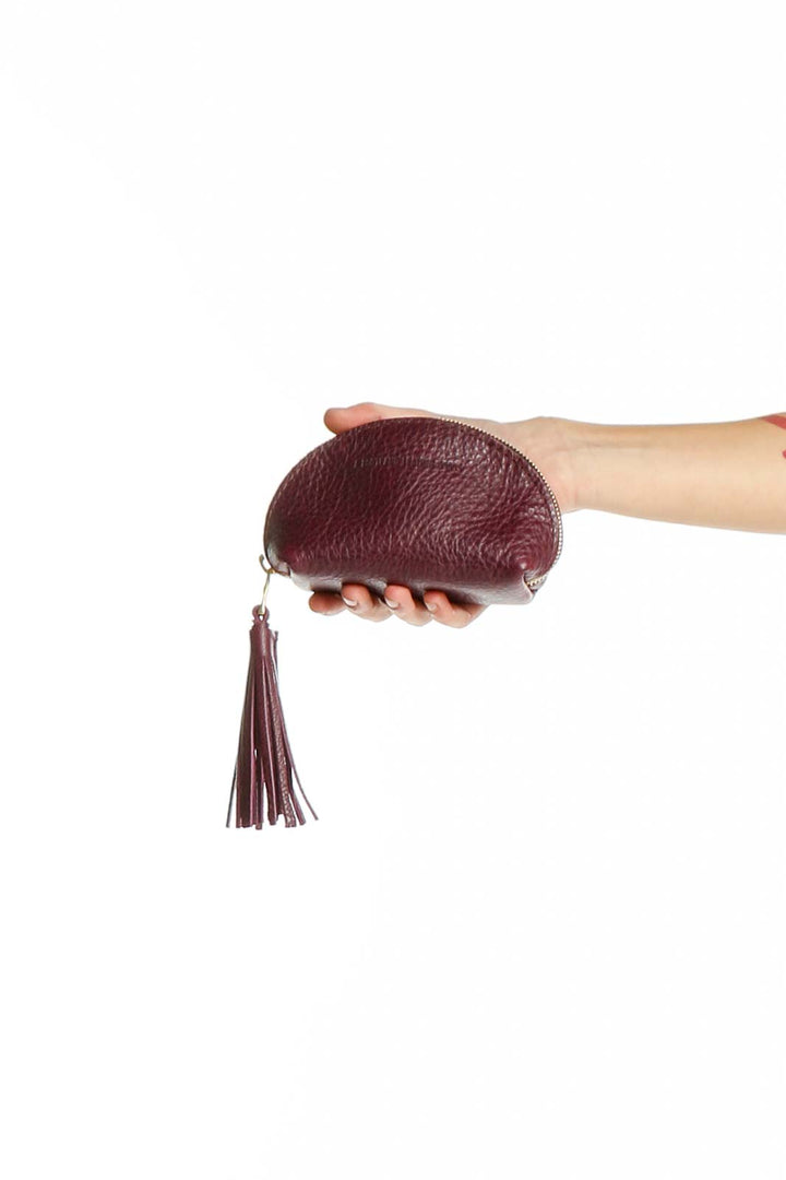 Burgundy leather clutch with tassel from A Portland leather goods, front view