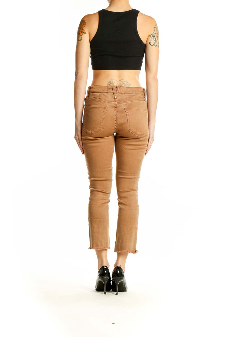 Side view of model wearing Marc By Marc Jacobs camel cropped slim fit jeans with black top