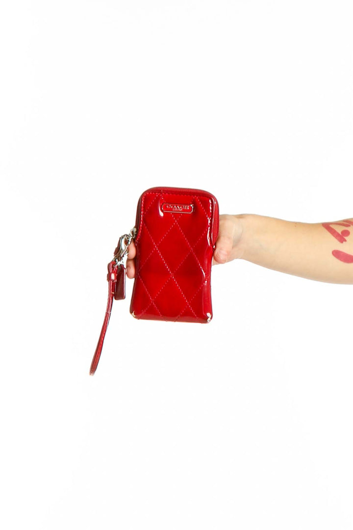 Front view of red quilted patent leather Coach wristlet clutch