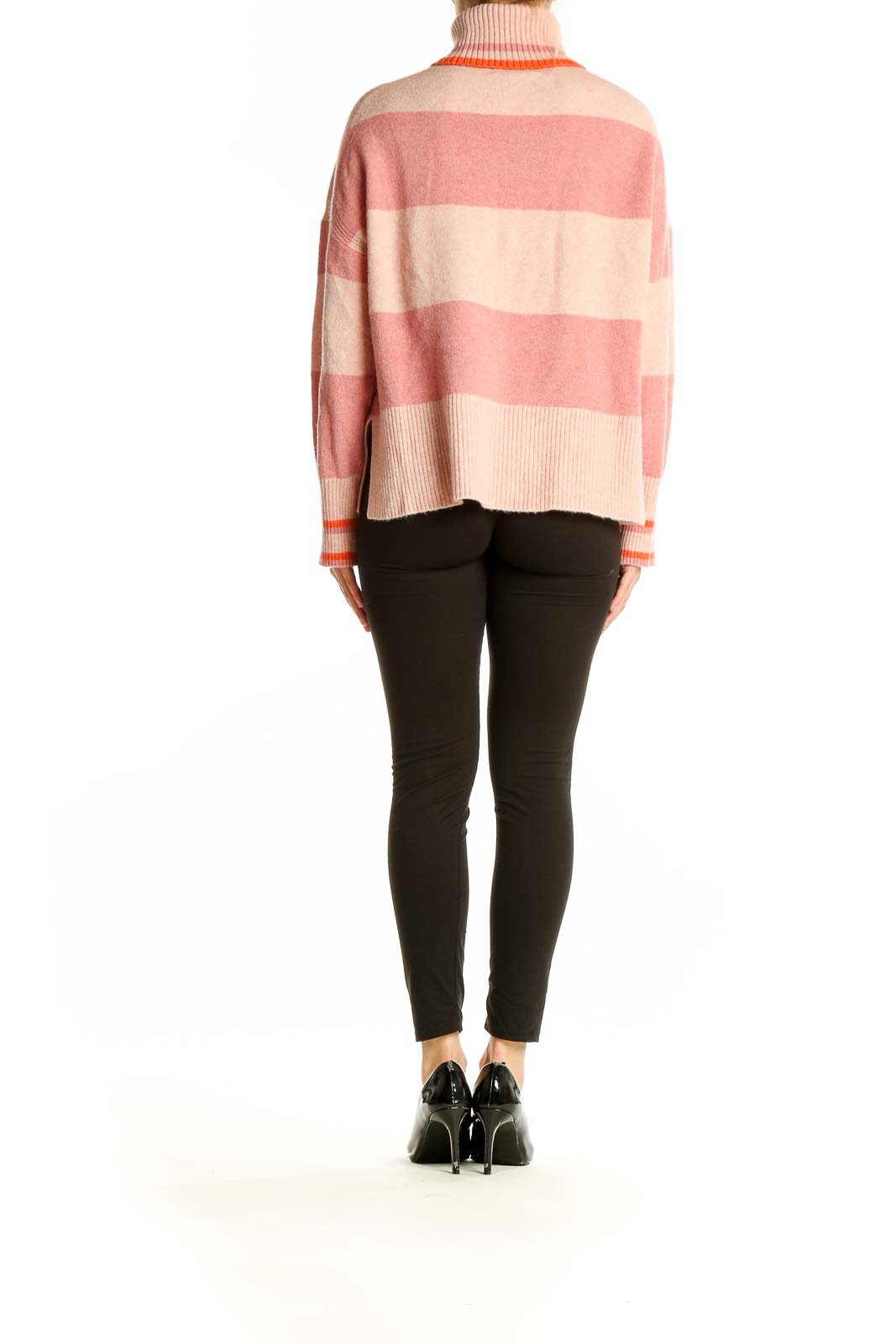 Side view of model wearing J.Crew pink striped turtleneck sweater with black pants