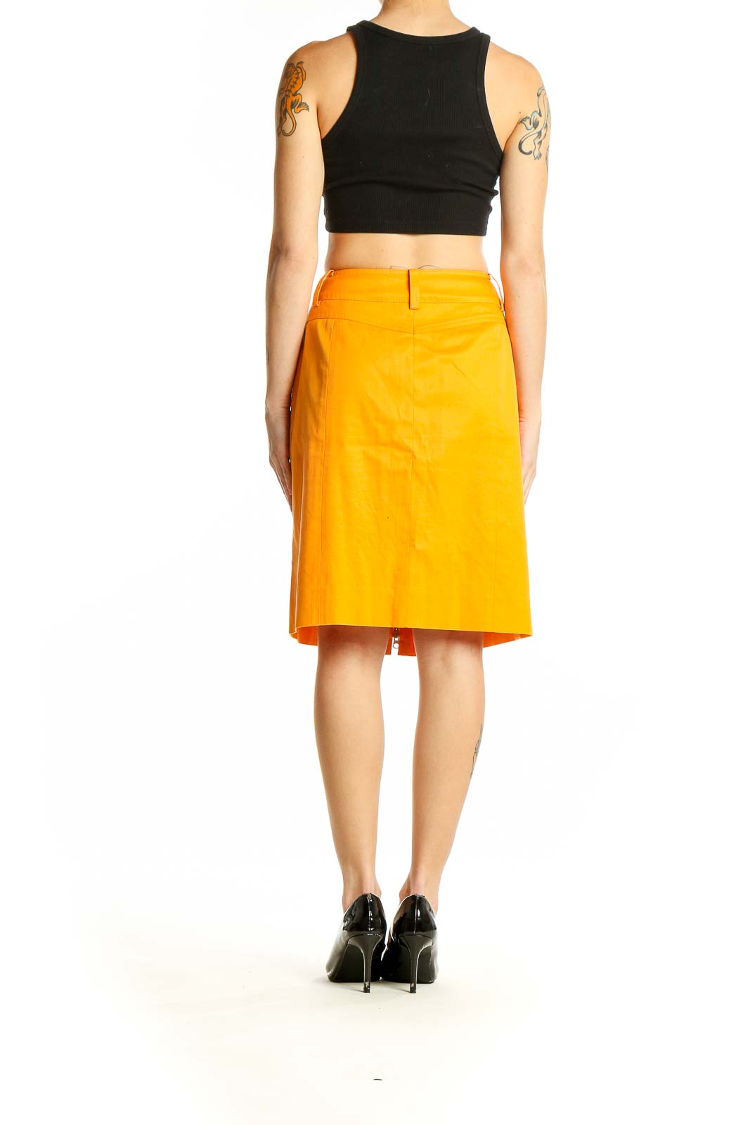 Side view of yellow Carlisle pencil skirt worn with black top