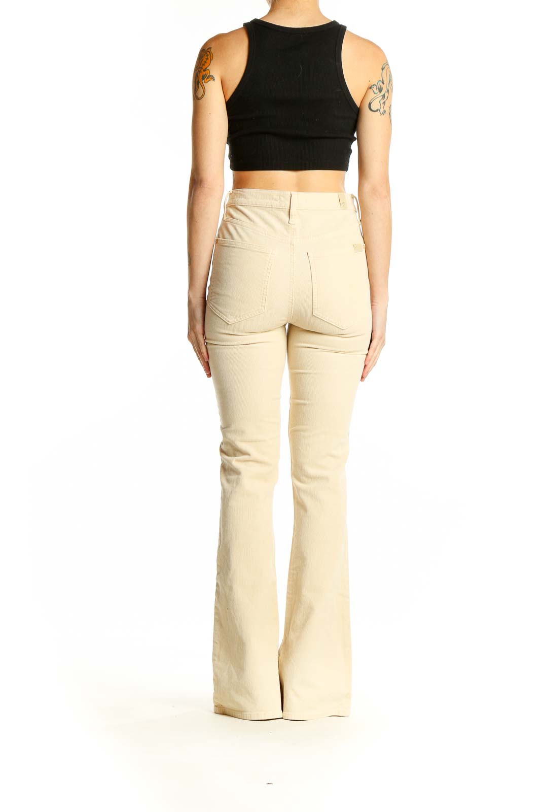 Side view of model wearing 7 For All Mankind cream high-waisted flared pants