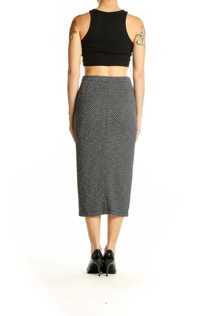 Side view of Banana Republic Black and White Herringbone Midi Skirt paired with black crop top