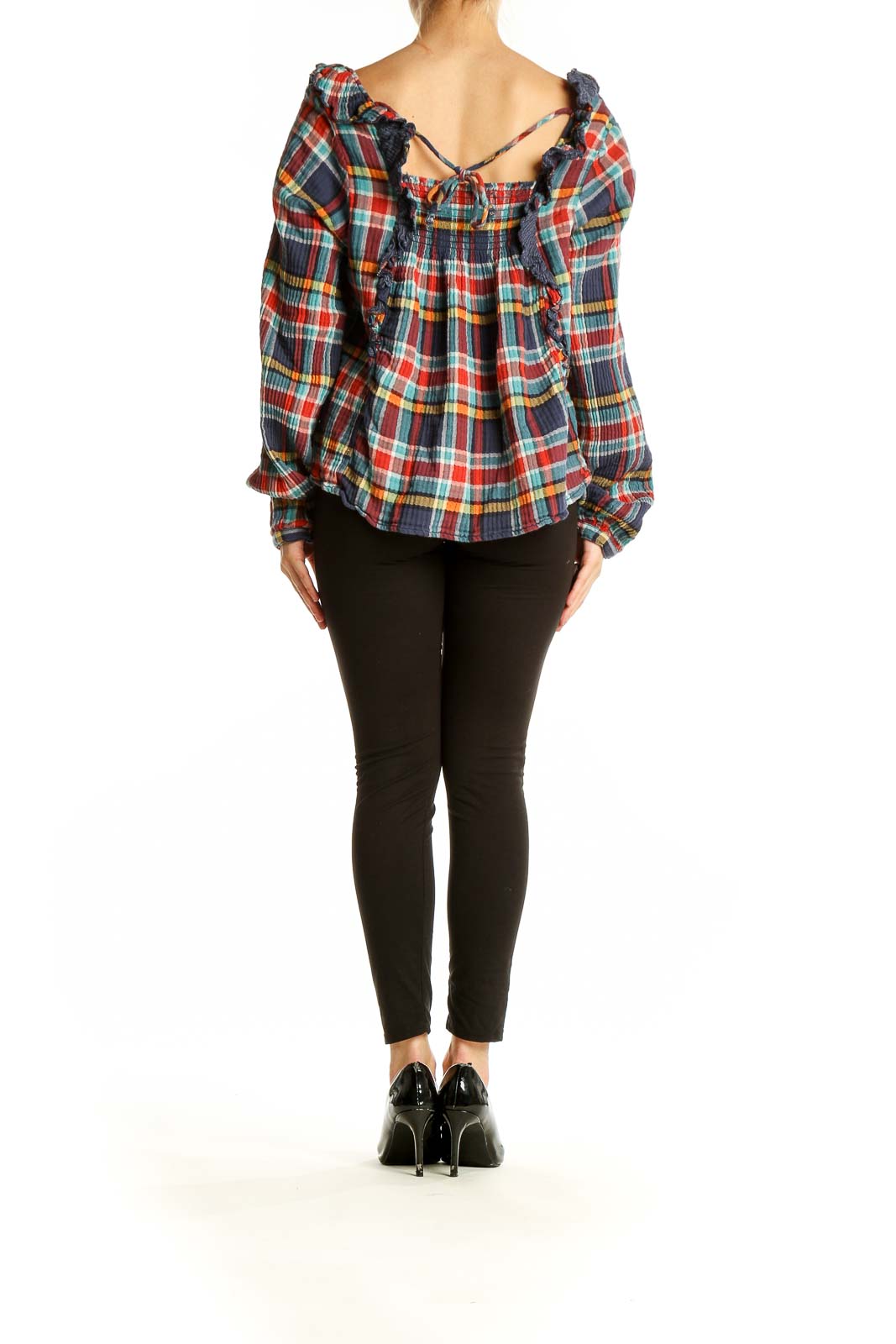 Side view of WE THE FREE multicolor plaid off-shoulder crop top on model with black pants