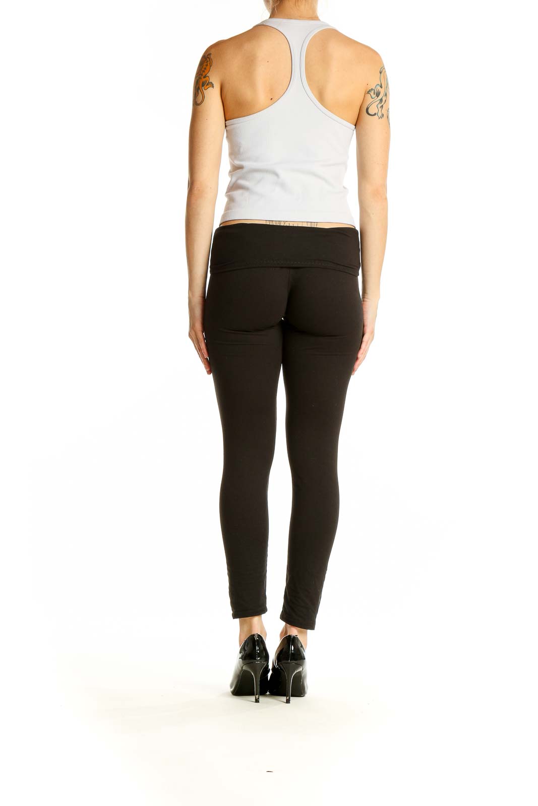 Side view of white SilkRoll racerback crop top paired with black leggings