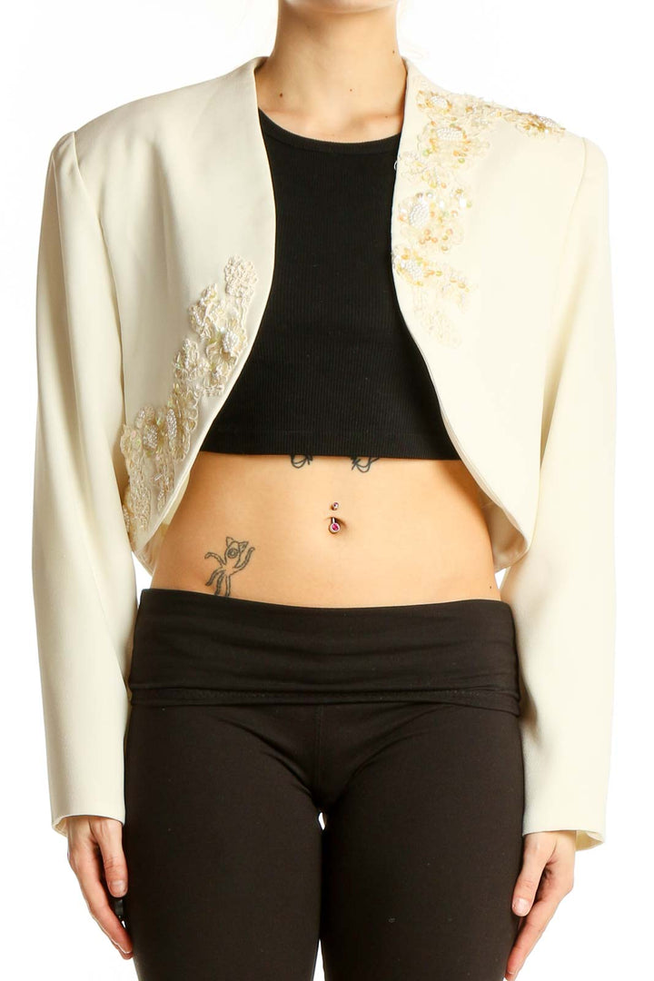 Front view of cream embellished cropped bolero jacket by SilkRoll