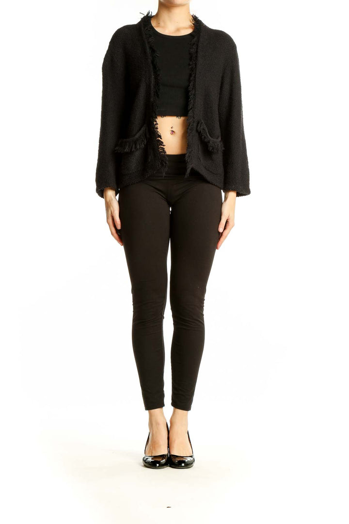 Front view of DKNY black open front cardigan with frayed edges