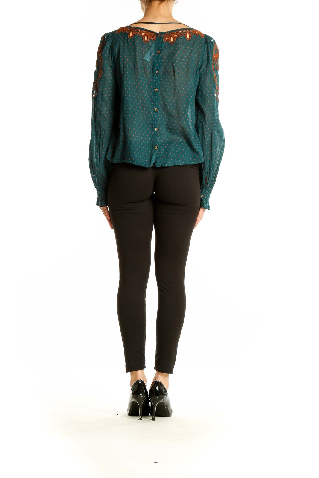 Side view of teal Free People peasant top showing embroidery detail