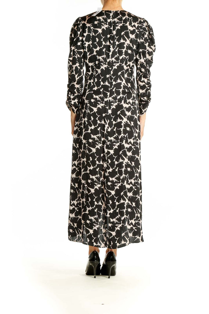 Side view of Gap black floral print maxi dress showing high-low hemline