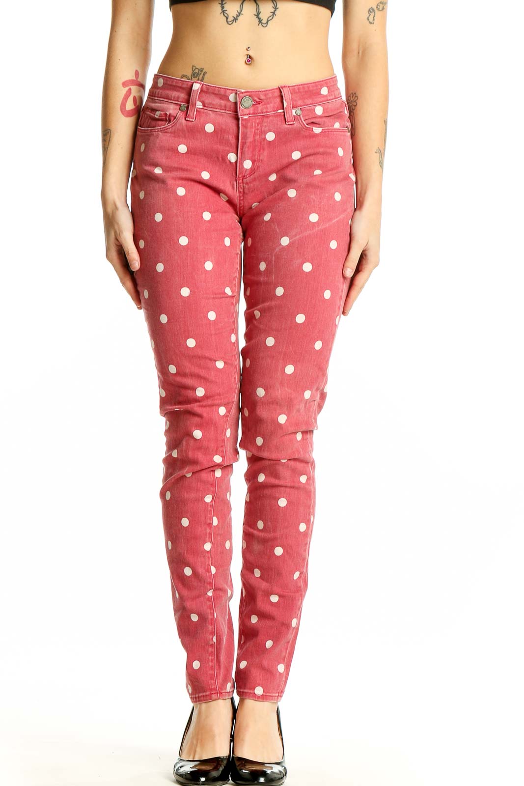 Front view of Paige pink polka dot skinny jeans on model