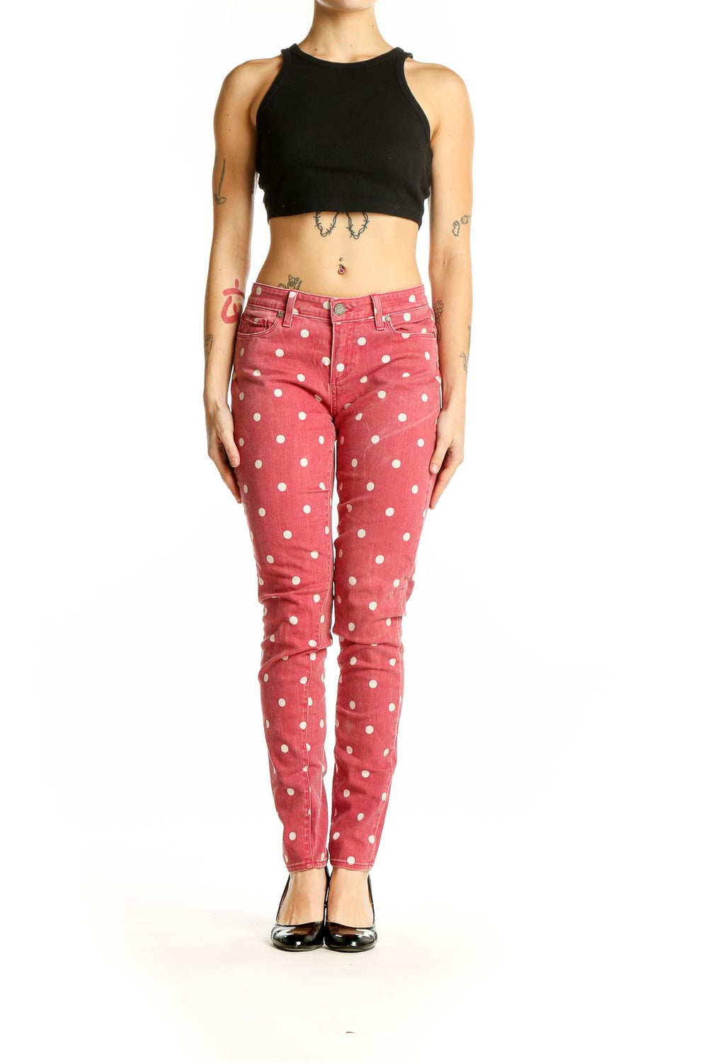 Front view of Paige pink polka dot skinny jeans on model