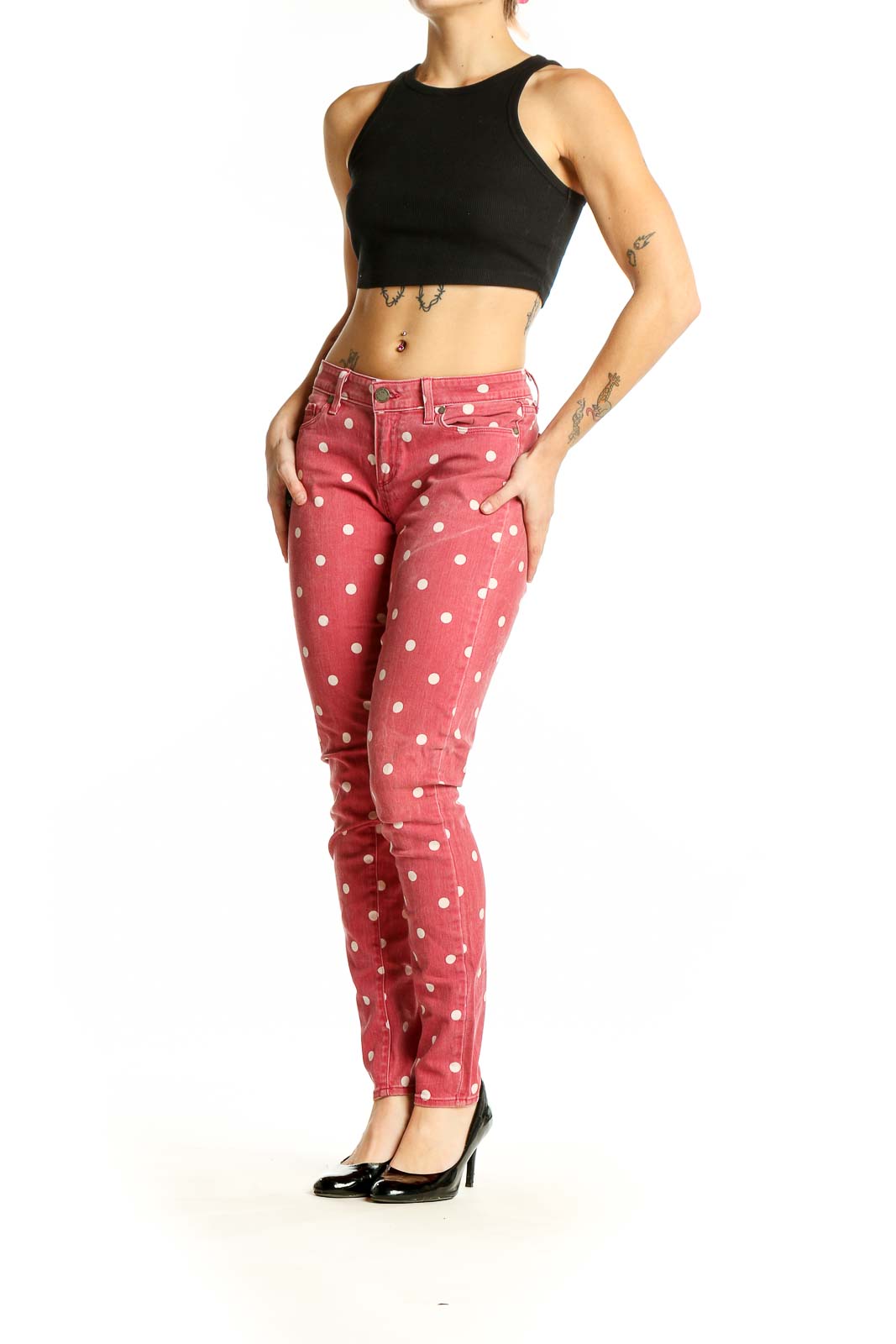 Front view of Paige pink polka dot skinny jeans on model