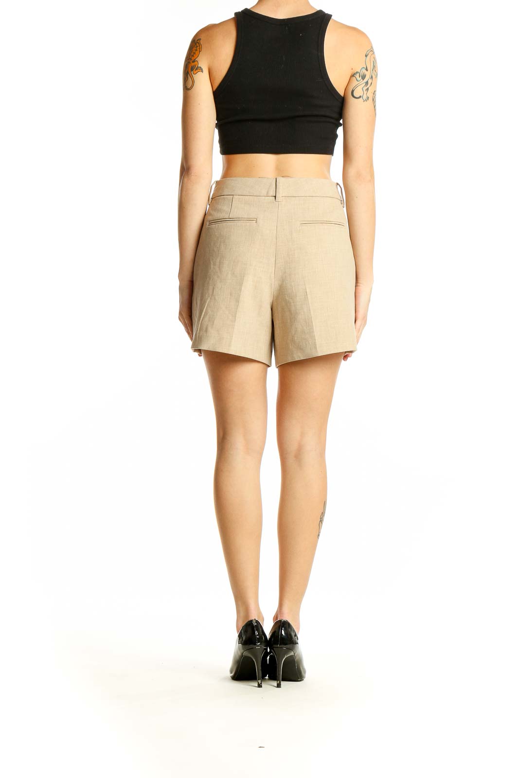 Side view of Wilfred beige tailored shorts on model with black top