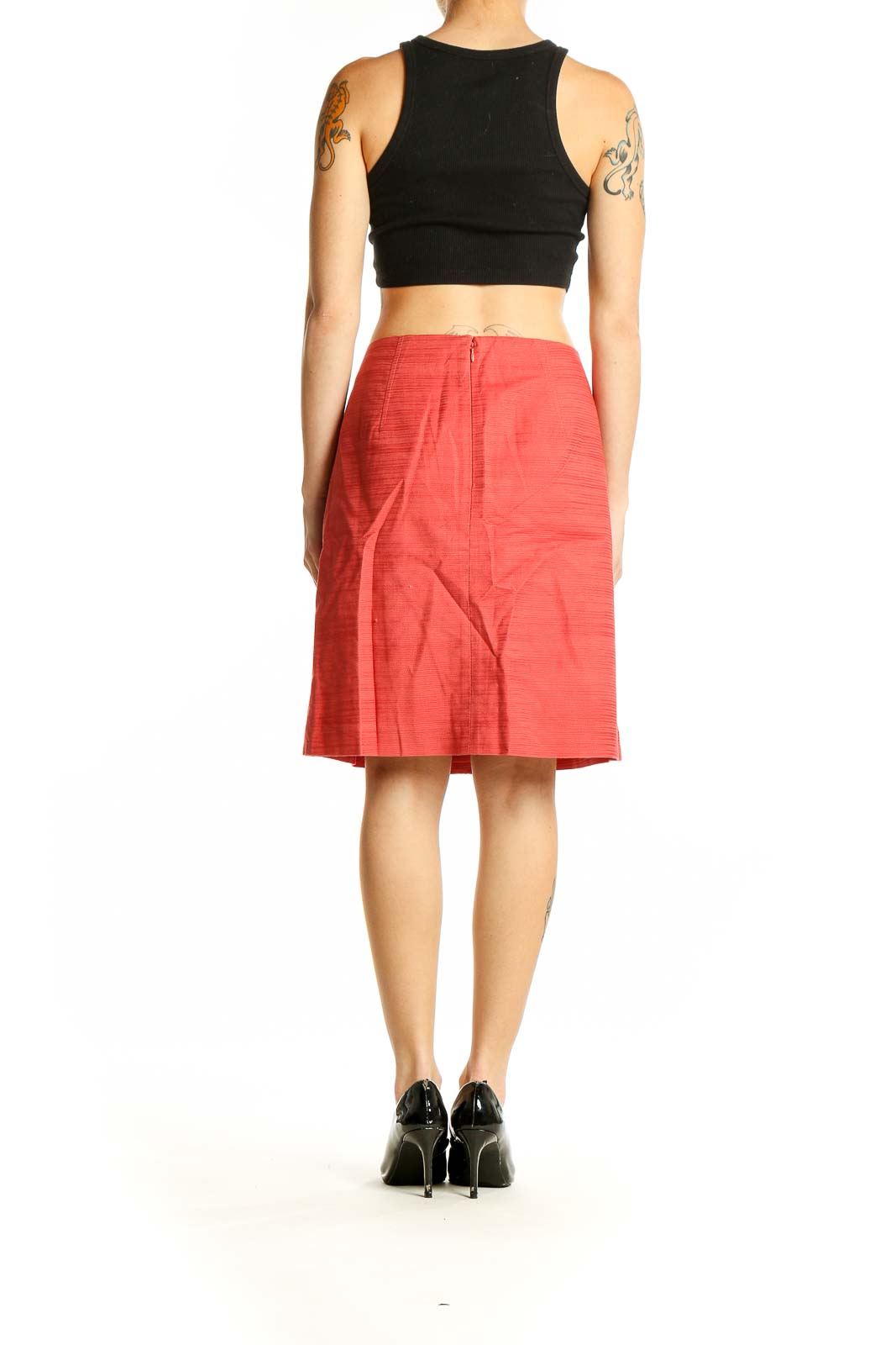 Side view of Ann Taylor coral textured pencil skirt with black top