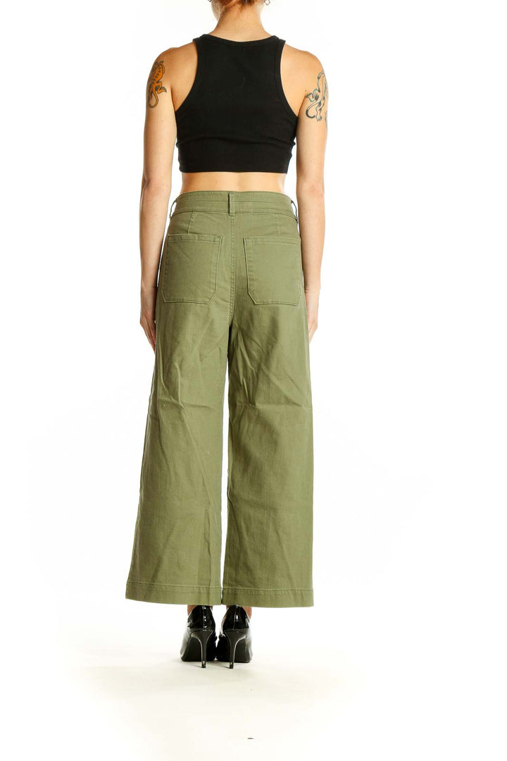 Side view of model wearing LOFT olive wide-leg pants with black crop top