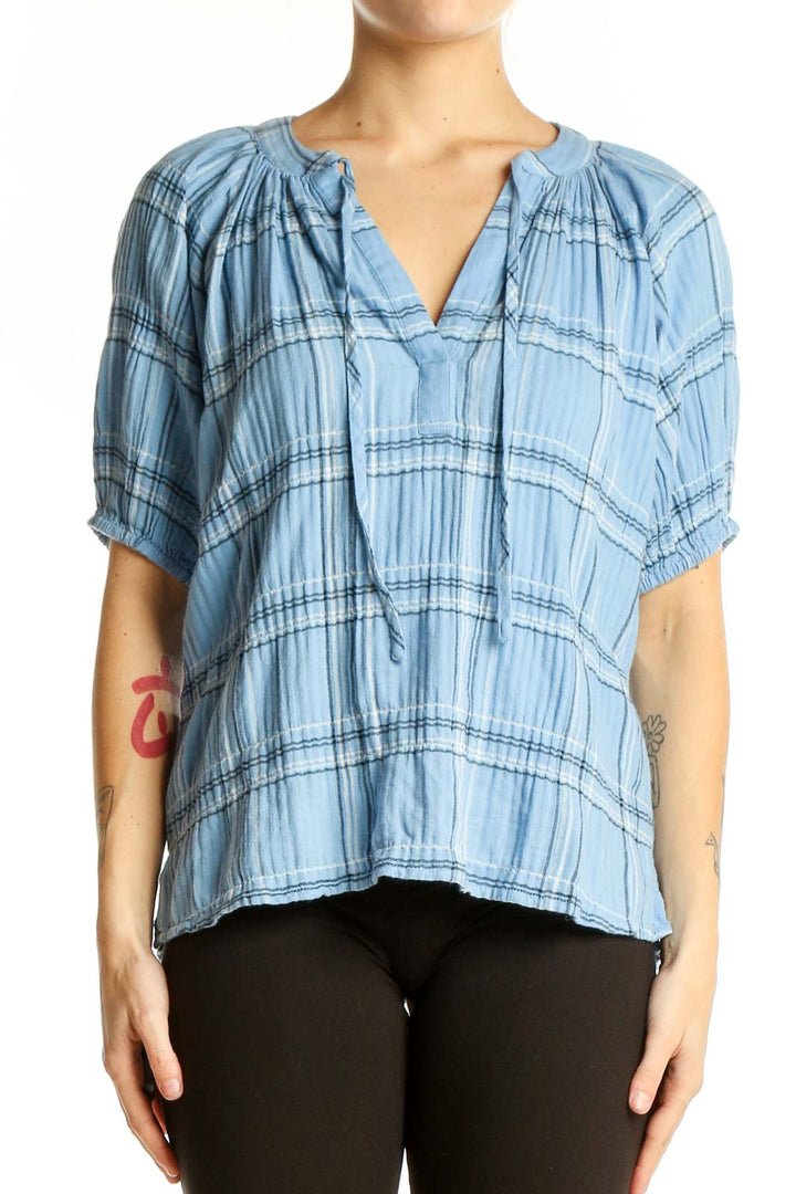 Front view of light blue plaid LOFT top with V-neck and short puffed sleeves