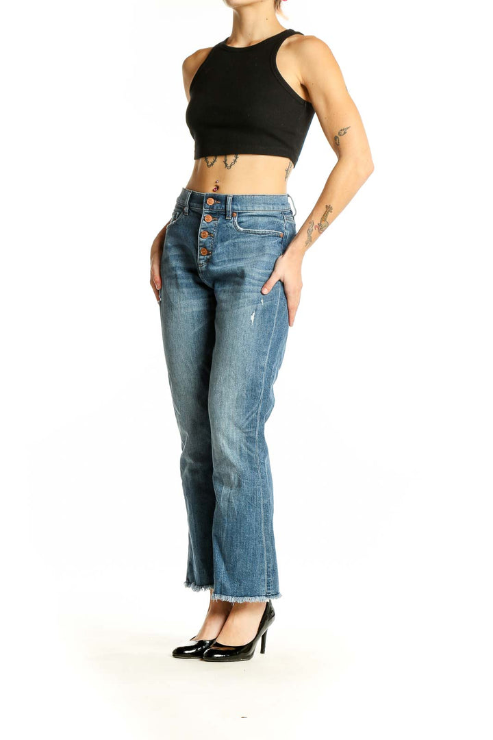 Front view of LOFT blue cropped flare jeans with button-fly