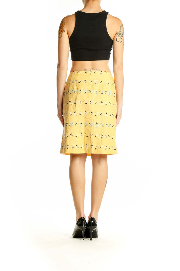 Side view of Ann Taylor yellow floral printed pencil skirt with black top