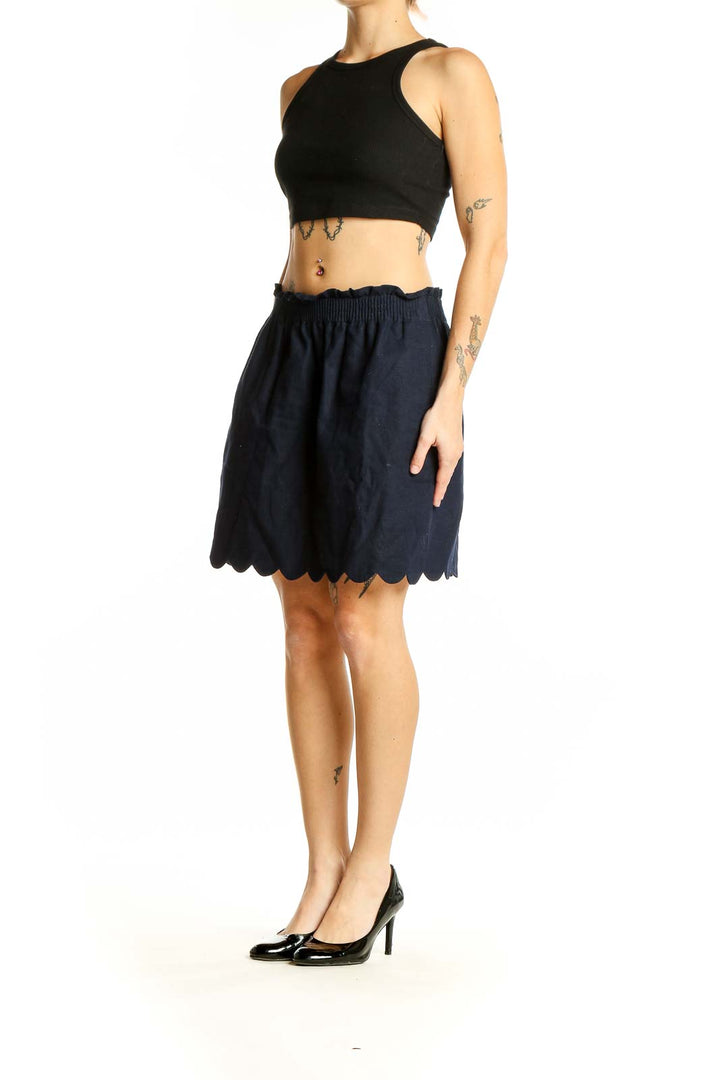 Front view of J.Crew navy skirt with scalloped hem