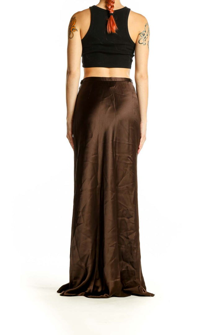 Side view of Ann Taylor brown satin maxi skirt on model with black crop top