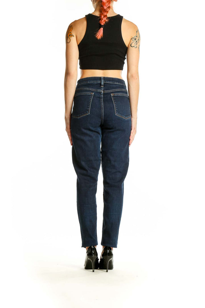 Back view of J.Crew dark blue straight leg jeans on model