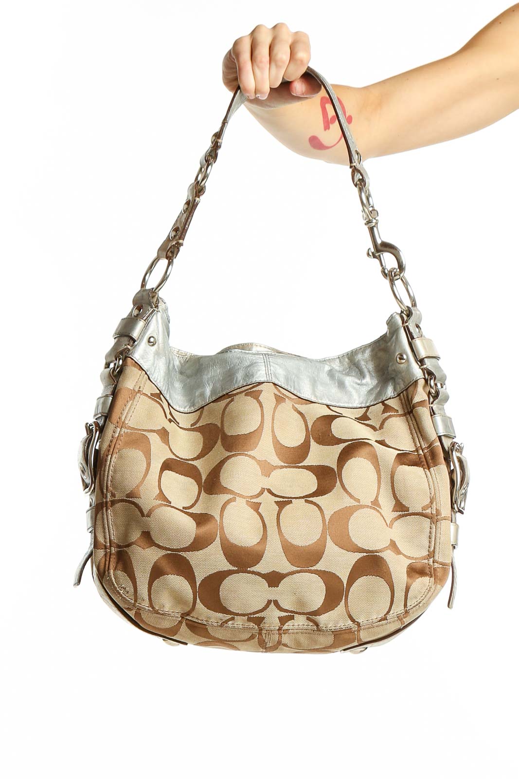 Front view of Coach Signature Print Hobo Bag in beige with silver accents