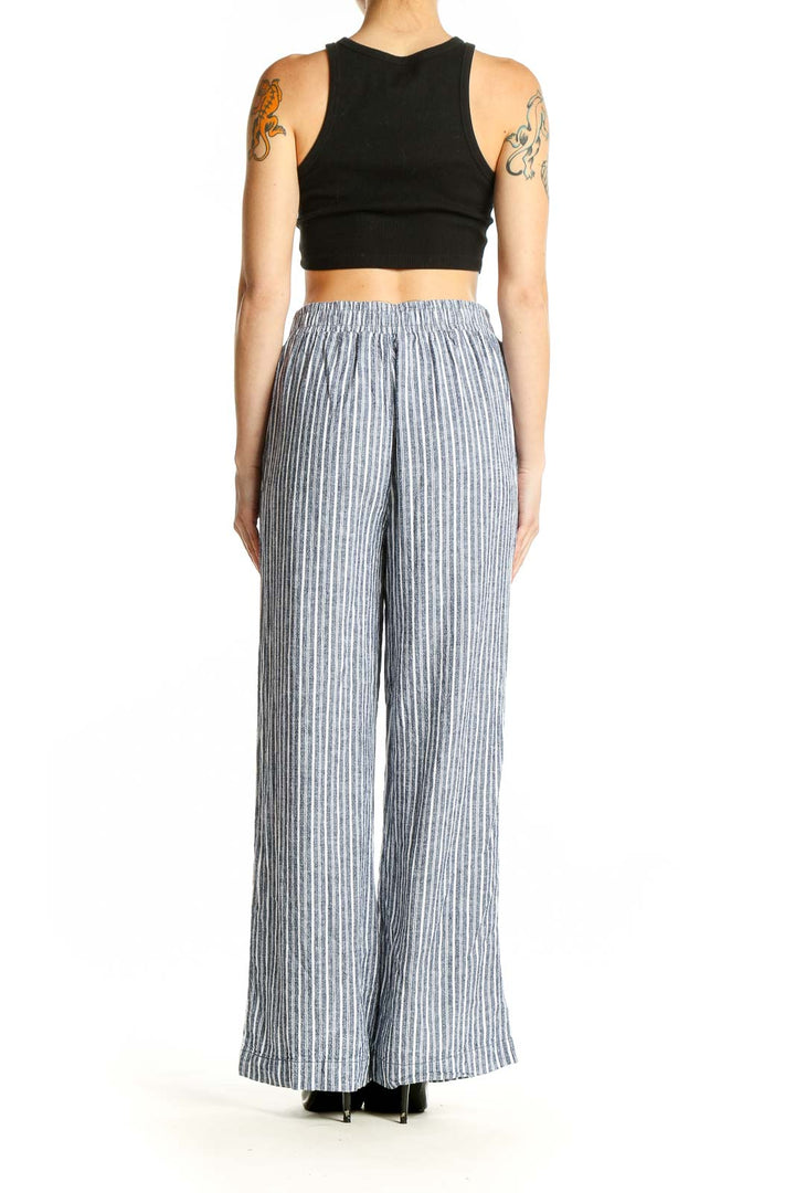 Side view of model wearing Briggs gray striped wide-leg linen blend pants