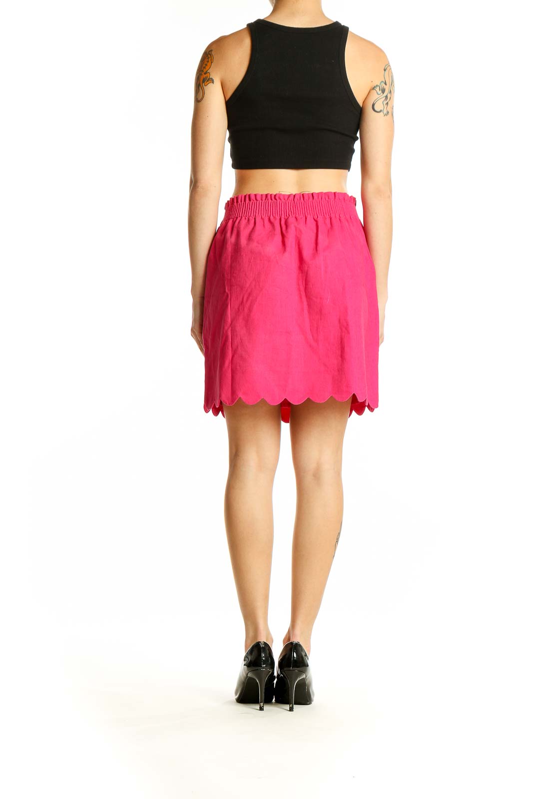 Side view of pink J. by J.Crew skirt paired with black top