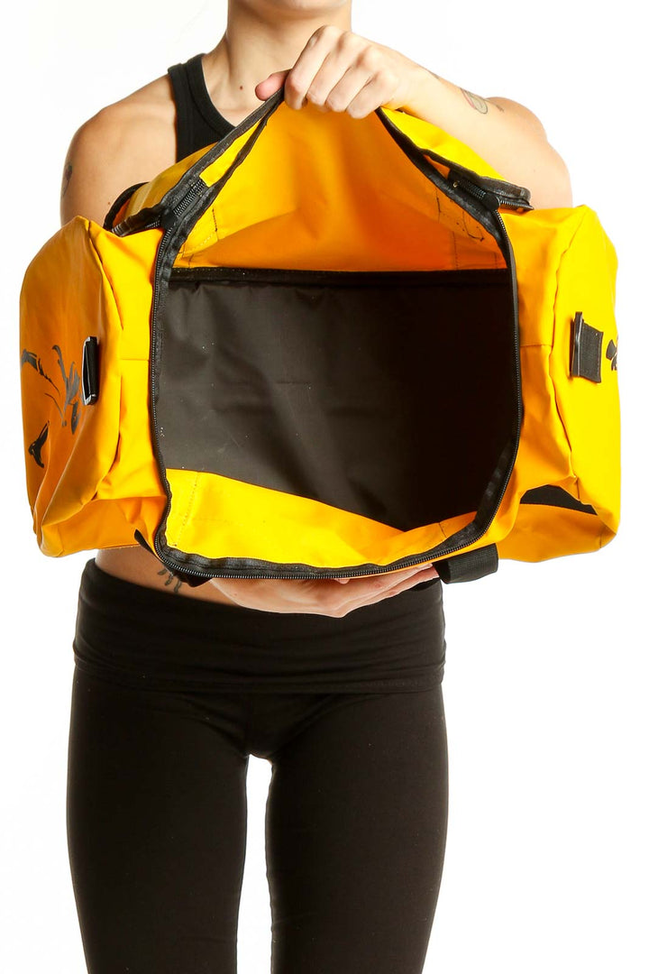 Side view of yellow messenger bag worn by model in athletic wear